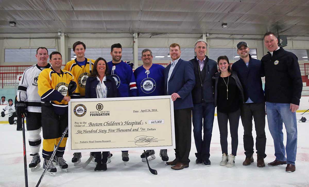 Team Bain Capital captain Jay Corrigan (second from left) with draft pick Ray Bourque (second from right) and NHL Pro-Am founder Mike Griffin (at right)